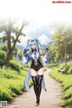 A woman with long blue hair walking down a path.