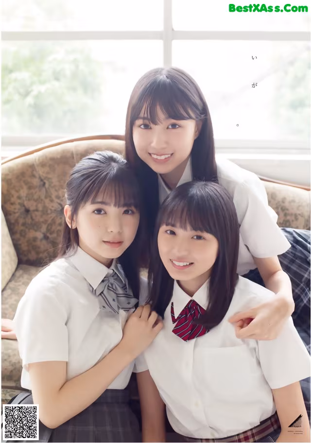 A group of young women in school uniforms posing for a picture.