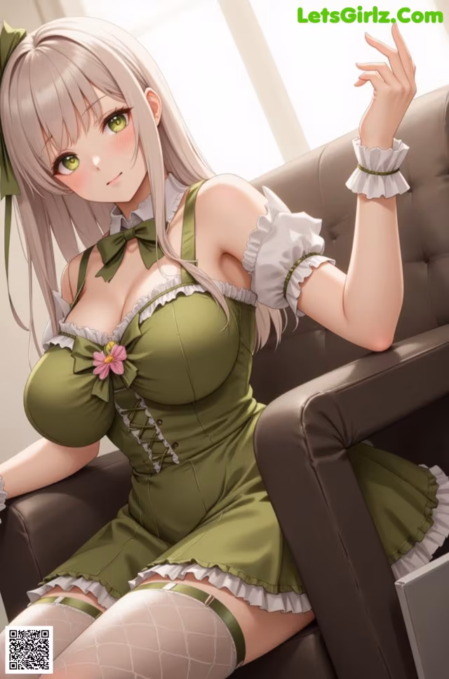 A woman in a green dress sitting on a brown chair.