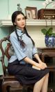 a woman sitting on top of a wooden chair