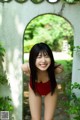 A woman in a red bathing suit posing for a picture.