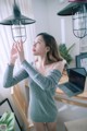 a woman standing in front of a laptop computer